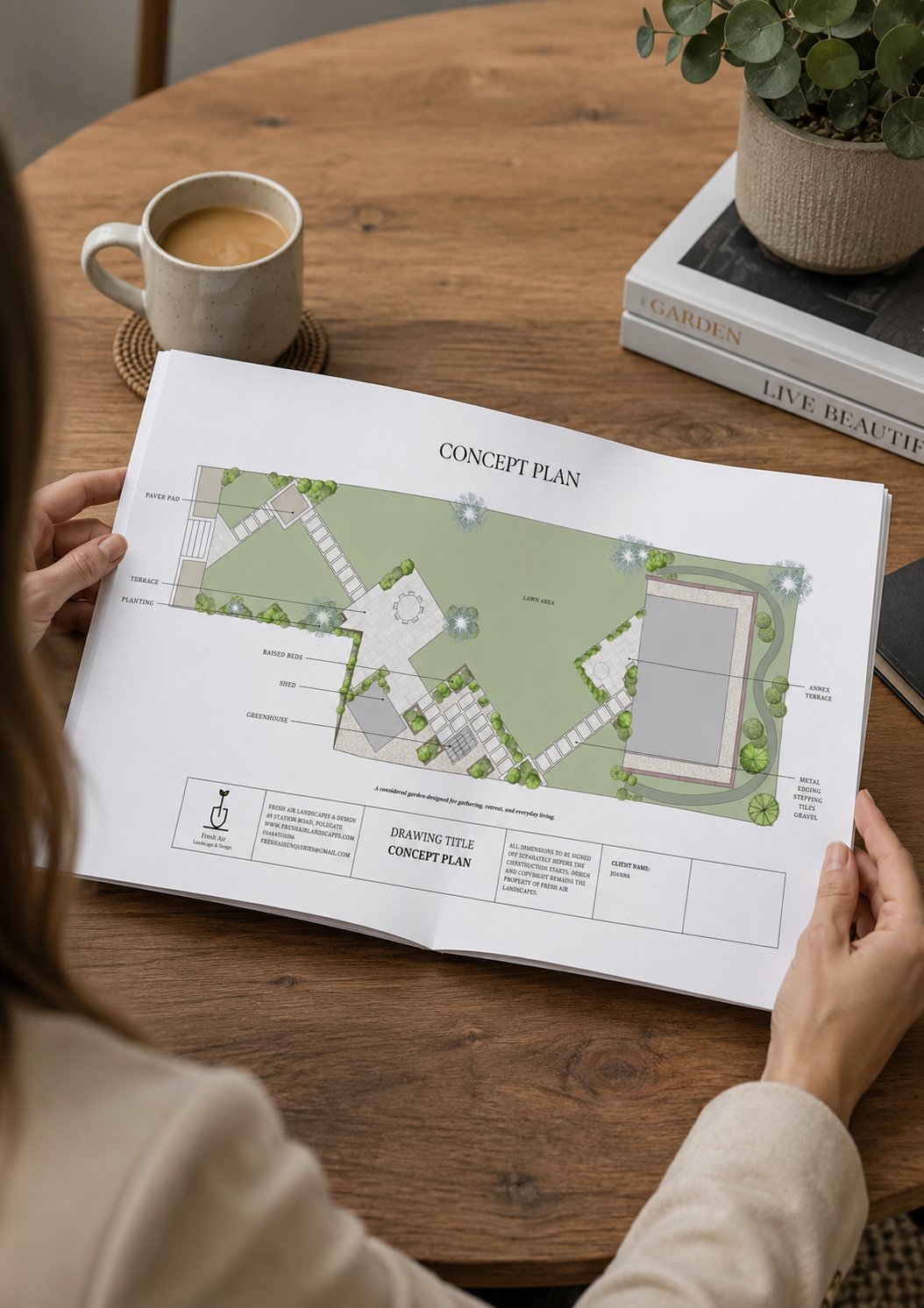 Designer presenting a hand-drawn concept plan for a luxury garden