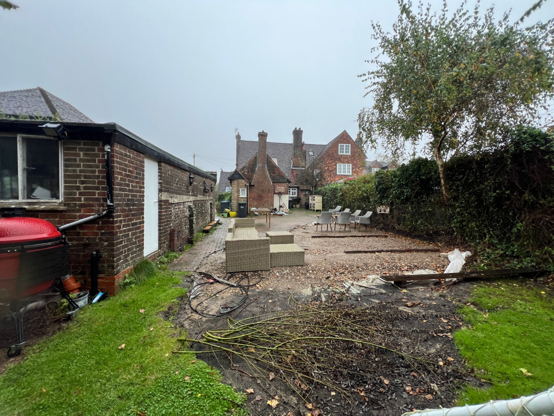 Original garden - gravel area, scattered furniture and overgrown lawn before transformation