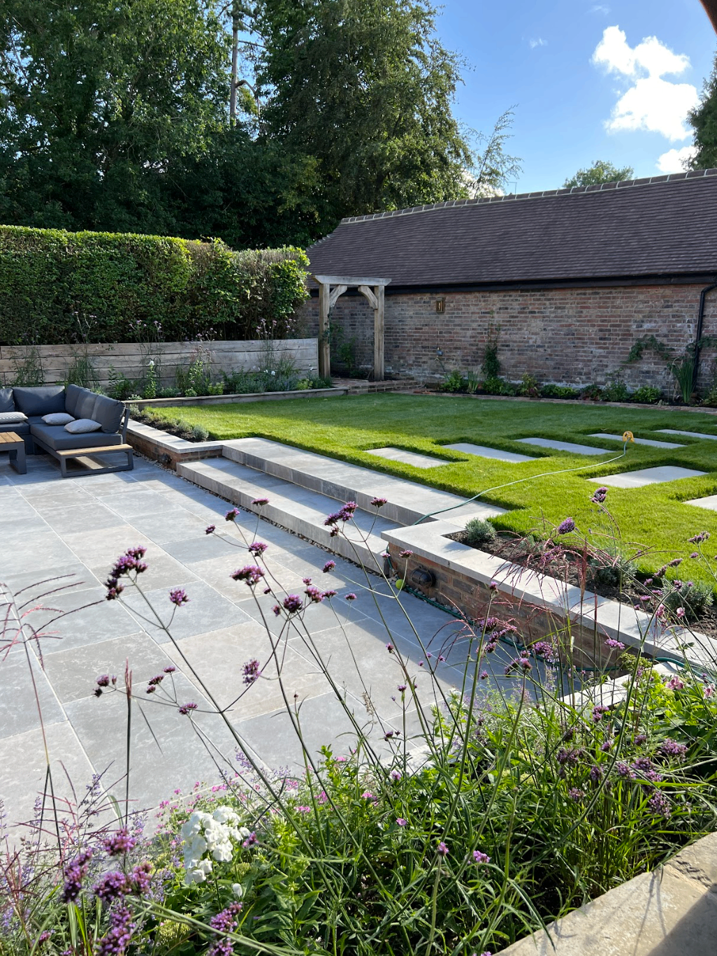 Country garden with water feature and stone terracing