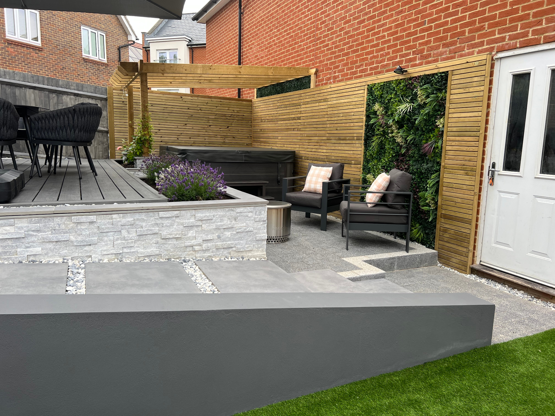 Finished garden - raised entertaining deck beside a living wall and secluded lounge seating