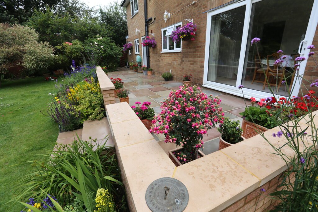 Landscape garden with flowers and a patio in haywards heath, cuckfield, sussex